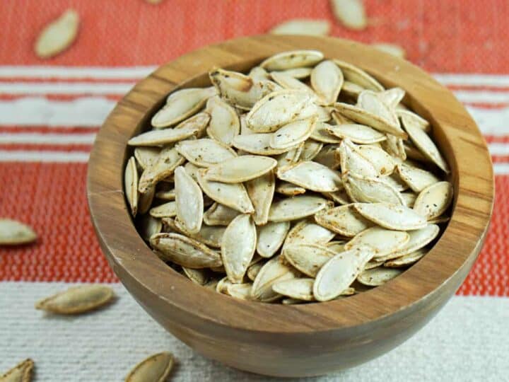 This toasted salted pumpkin seeds recipe is ridiculously easy. Wash & strain, season, dry and roast for deliciously crisp seeds. Then crunch away and enjoy!