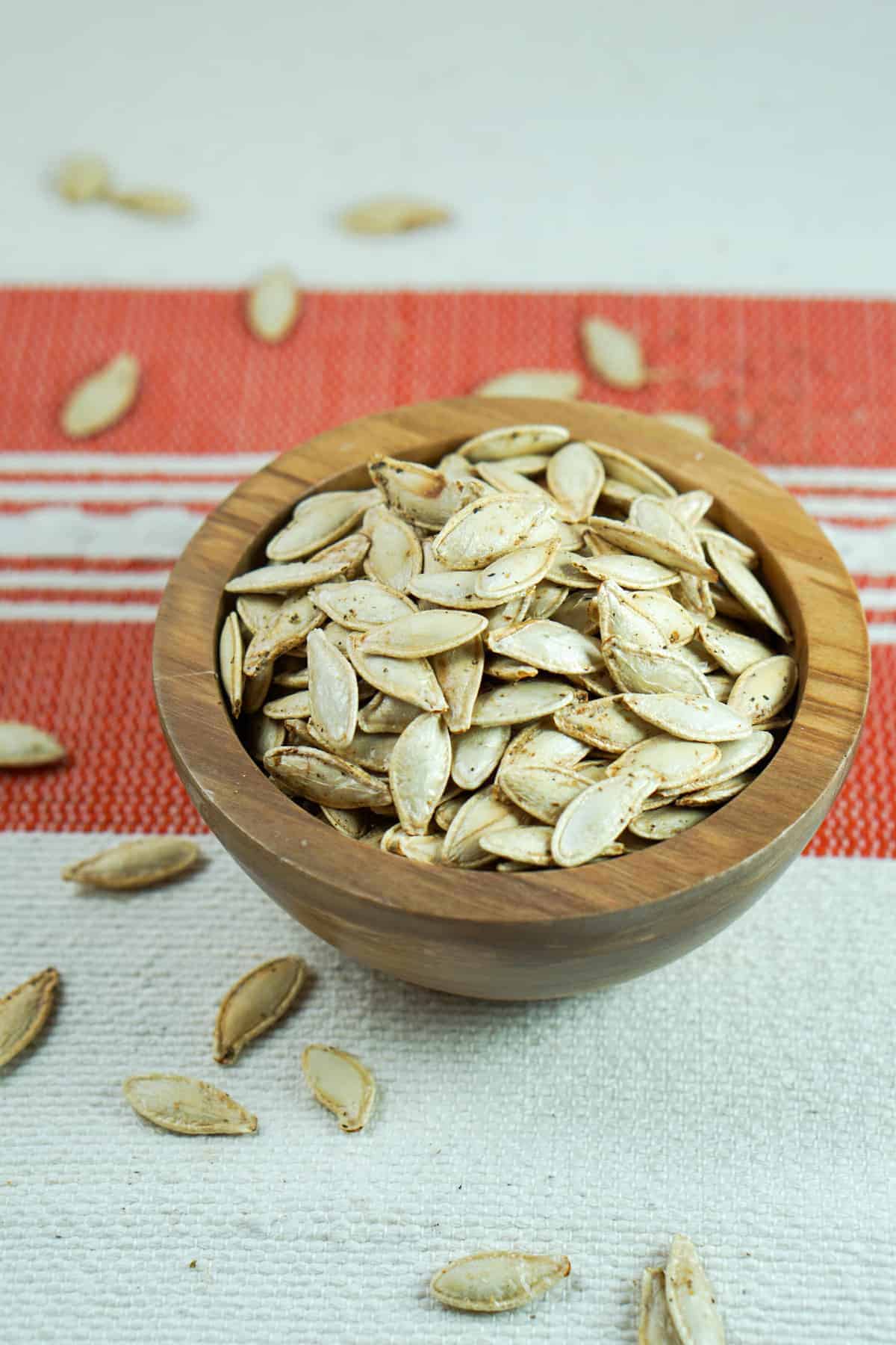 This toasted salted pumpkin seeds recipe is ridiculously easy. Wash & strain, season, dry and roast for deliciously crisp seeds. Then crunch away and enjoy!
