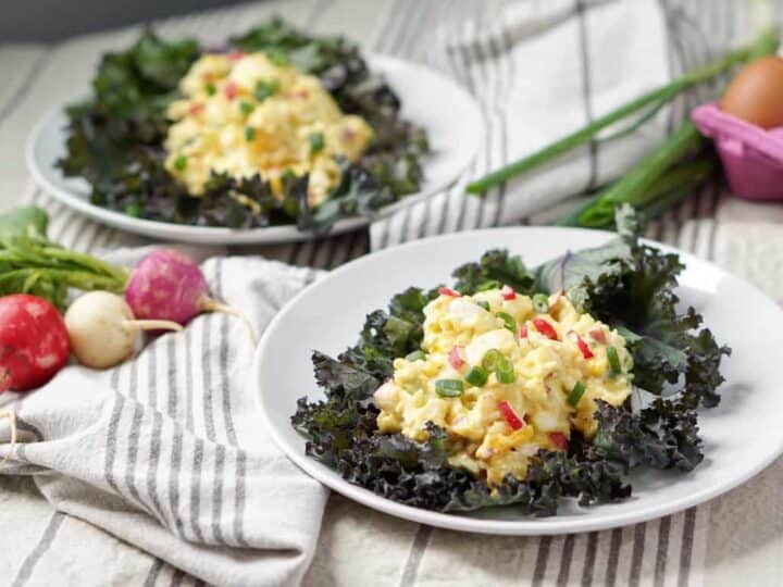 A cleaned up and simple 5 ingredient Egg Salad Kale Wraps recipe: pasture raised eggs, paleo mayo, fresh radishes and green onions all wrapped in Red Kale