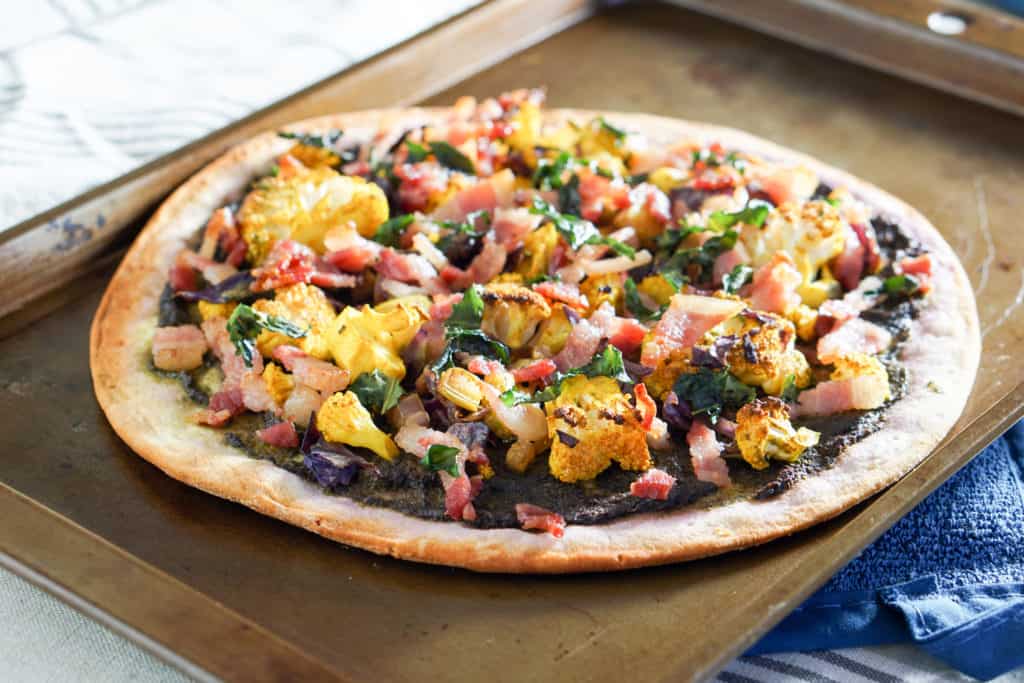 This Roasted Cauliflower and Kale Sauce Flatbread Recipe is a completely reinvented look at pizza: gluten free crust, nightshade free sauce, and dairy free.