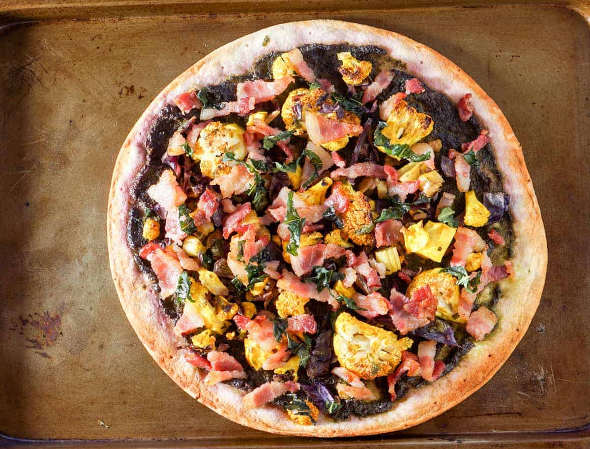 This Roasted Cauliflower and Kale Sauce Flatbread Recipe is a completely reinvented look at pizza: gluten free crust, nightshade free sauce, and dairy free.