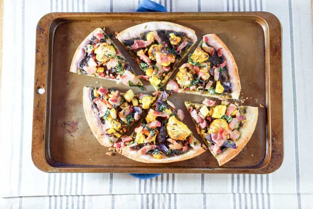 This Roasted Cauliflower and Kale Sauce Flatbread Recipe is a completely reinvented look at pizza: gluten free crust, nightshade free sauce, and dairy free.