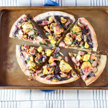 This Roasted Cauliflower and Kale Sauce Flatbread Recipe is a completely reinvented look at pizza: gluten free crust, nightshade free sauce, and dairy free.