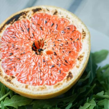 This brûléed grapefruit recipe showcases caramelized sugars without added refined sugars and cream. Add tossed arugula for a paleo, whole 30, GF, DF lunch.