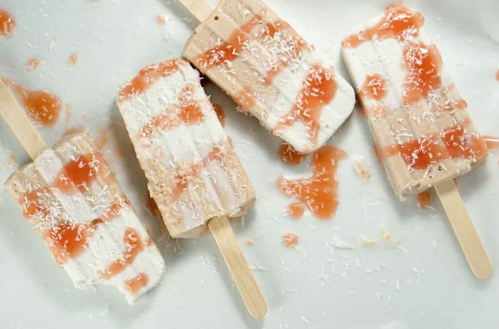 Fresh rhubarb and coconut cream are sweetened with dates and maple syrup for this refined sugar free and dairy free Paleo Rhubarb Coconut Popsicles recipe