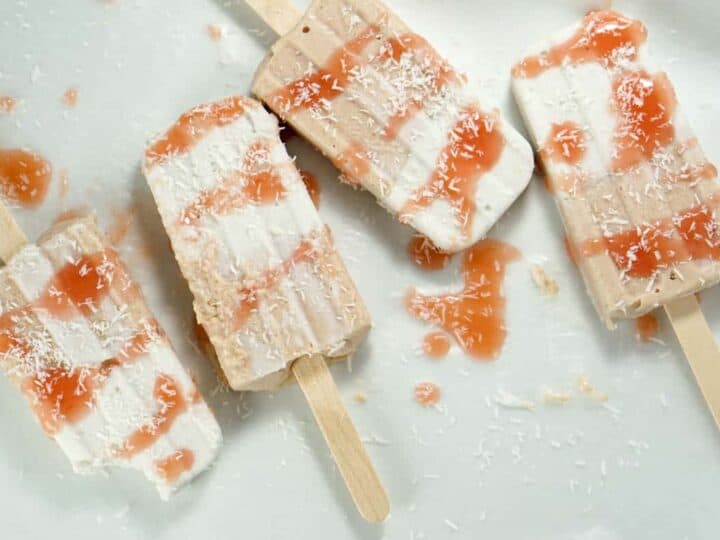Fresh rhubarb and coconut cream are sweetened with dates and maple syrup for this refined sugar free and dairy free Paleo Rhubarb Coconut Popsicles recipe