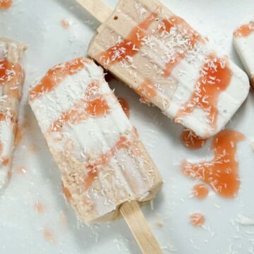 Fresh rhubarb and coconut cream are sweetened with dates and maple syrup for this refined sugar free and dairy free Paleo Rhubarb Coconut Popsicles recipe
