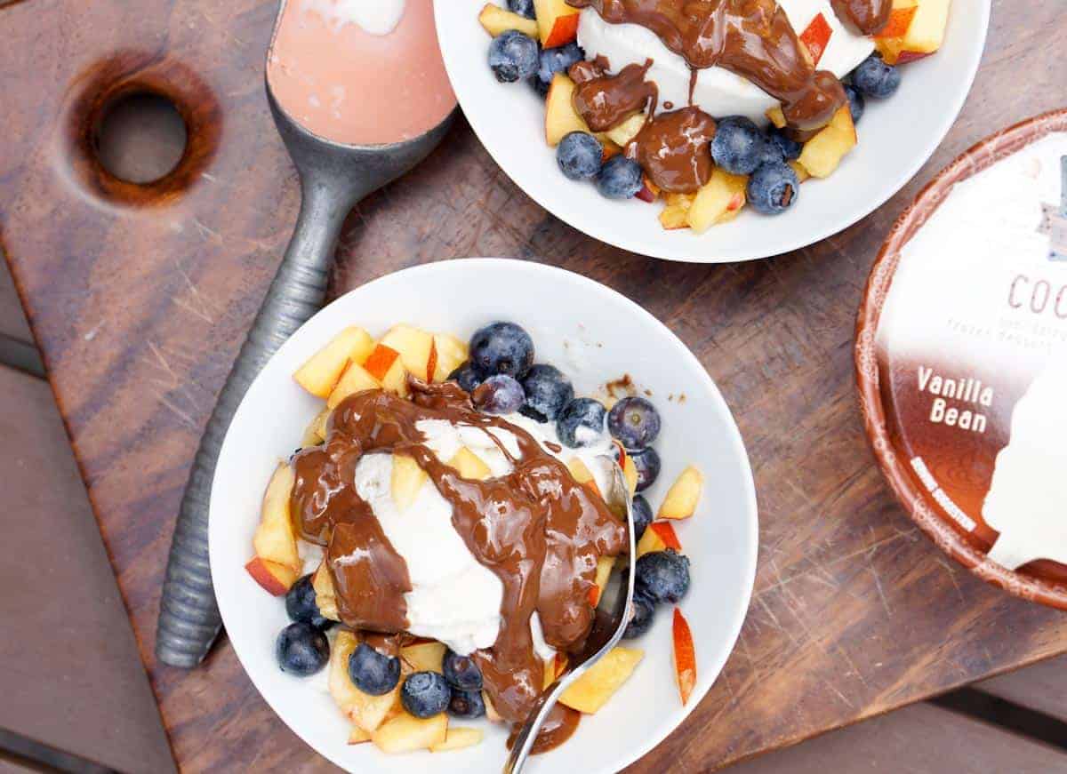 Fresh berries, creamy coconut ice cream, healthy magic shell make this great dairy free coconut berry sundae with homemade peanut butter chocolate drizzle