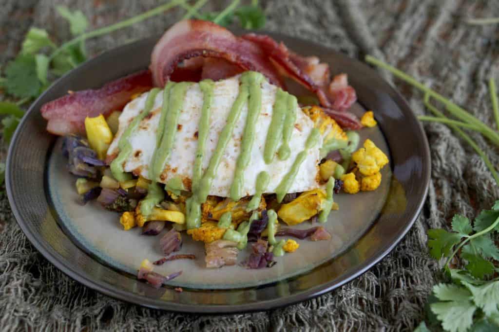 This easy and hearty AIP friendly Turmeric Cauliflower Bake Recipe is the perfect new staple for your paleo, grain free, and gluten free lifestyle, and great with an egg on top!
