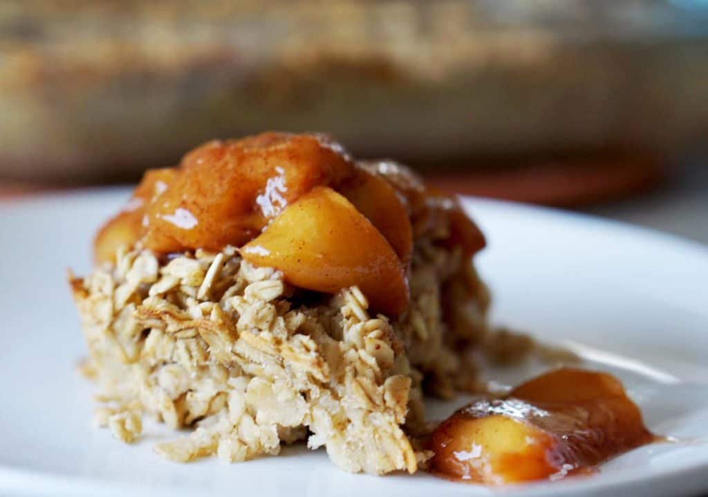 This easy egg alternative will save time in the mornings. Gluten free, dairy free, refined sugar free, paleo and vegan healthy baked oatmeal made with peaches and rhubarb recipe with just enough cinnamon and nutmeg.