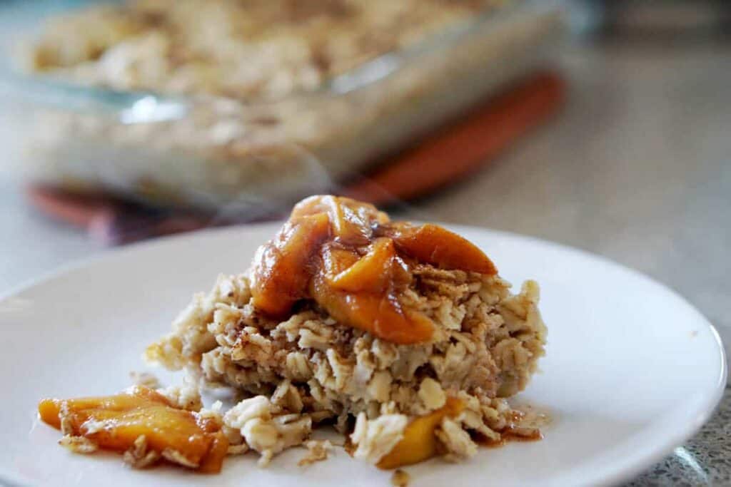 This easy egg alternative will save time in the mornings. Gluten free, dairy free, refined sugar free, paleo and vegan healthy baked oatmeal made with peaches and rhubarb recipe with just enough cinnamon and nutmeg.