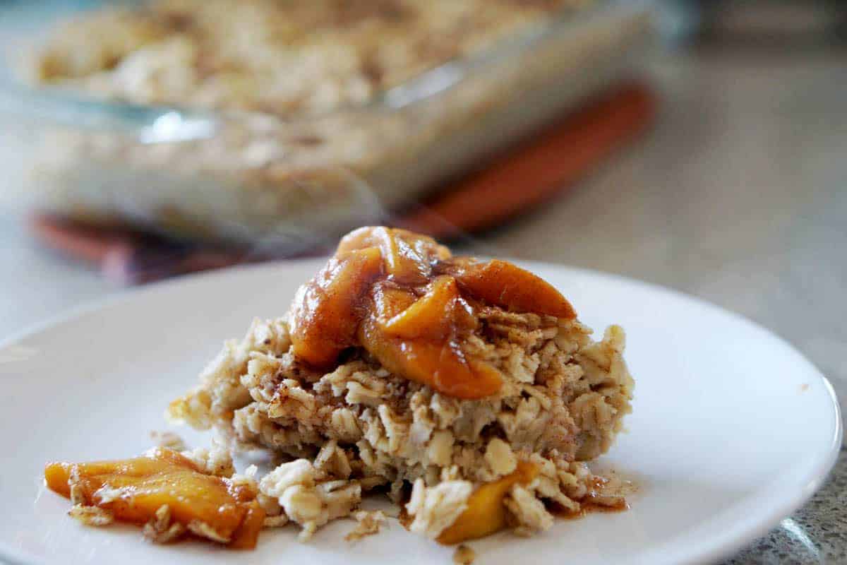This easy egg alternative will save time in the mornings. Gluten free, dairy free, refined sugar free, paleo and vegan healthy baked oatmeal made with peaches and rhubarb recipe with just enough cinnamon and nutmeg.
