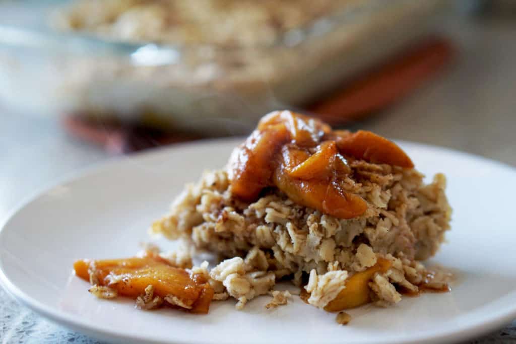 This easy egg alternative will save time in the mornings. Gluten free, dairy free, refined sugar free, paleo and vegan healthy baked oatmeal made with peaches and rhubarb recipe with just enough cinnamon and nutmeg.