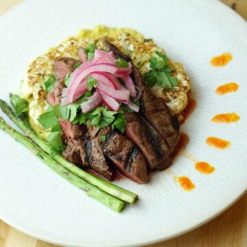 The Deconstructed Steak Taco on Curried Cauliflower Steak recipe merges the flavors of street tacos with Asian cuisine and the traditional steak house: Latin fusion that's healthy, gluten free, grain free and dairy free.
