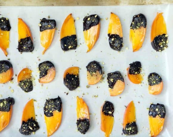 The flavors of buttery cinnamon persimmons, bittersweet chocolate, and freshly crushed pistachios make this quick, tasty and impressive dessert. Chocolate covered persimmons use just 5 ingredients, are ready in just a few minutes, and are sure to impress both your sweet-tooth and health-kick friends.