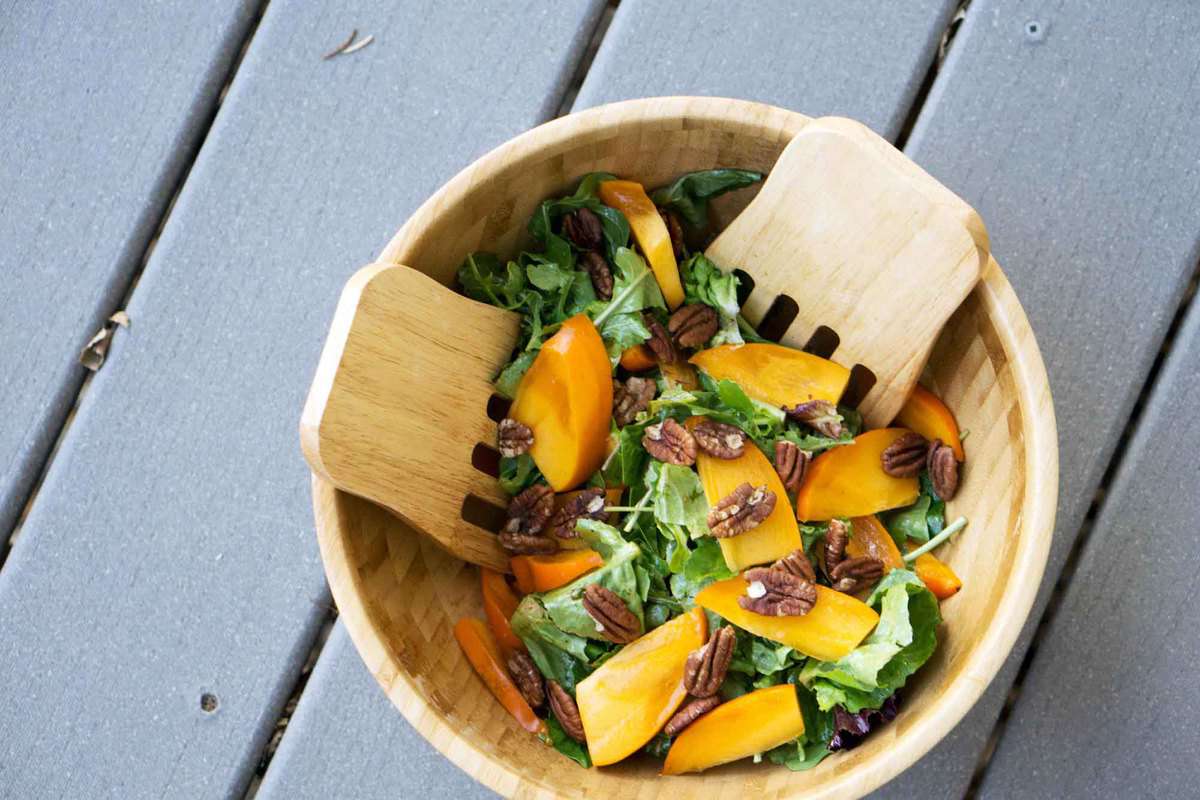 This quick salad is ready in minutes and brings some freshness to classically fall flavors. Just mix persimmons, arugula, toasted pecans and spice together for a naturally paleo and gluten free salad.