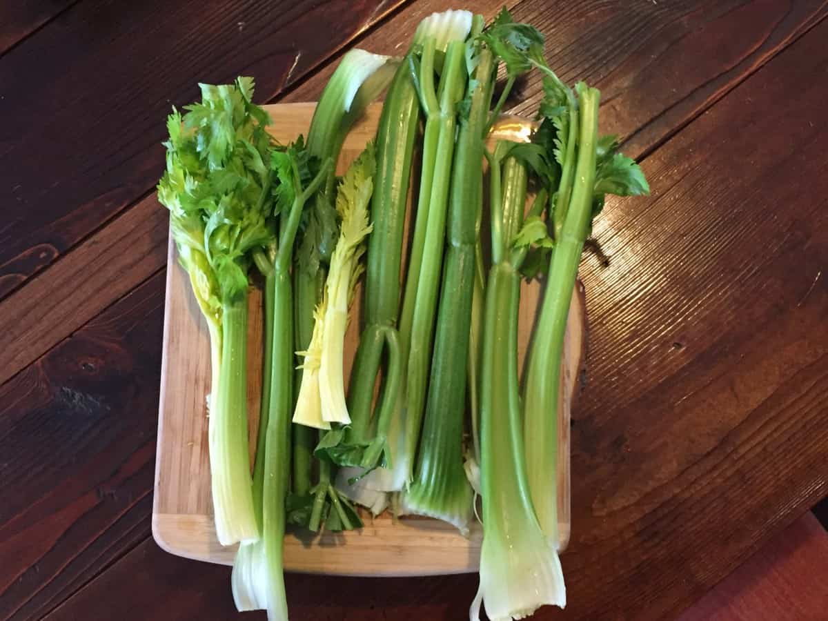 celery stalks on a cuting board waiting to be made into juice. Full of mineral salts good for healing the gut