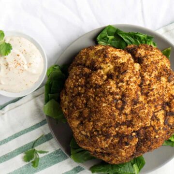 Roasted Harissa Cauliflower with Whipped Tahini makes a great side dish, dinner, and topping for salad bowls.