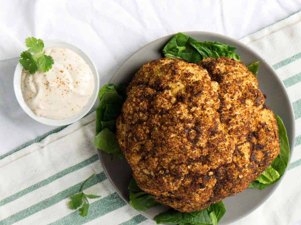 Roasted Harissa Cauliflower with Whipped Tahini makes a great side dish, dinner, and topping for salad bowls.
