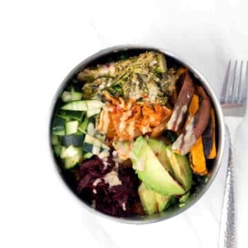 Loaded Kale Salad Bowl Recipe with Sweet potatoes, cucumbers, beets, Kimchi, tahini brocolini, avocado on tahini massaged Kale