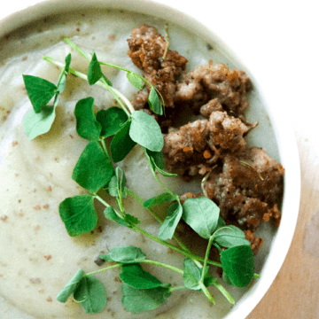 Creamy potato soup with Italian sausage and pea sprouts is savory, creamy, full of gut healing nutrients, perfect for when your craving carbs yet want to be healthy.