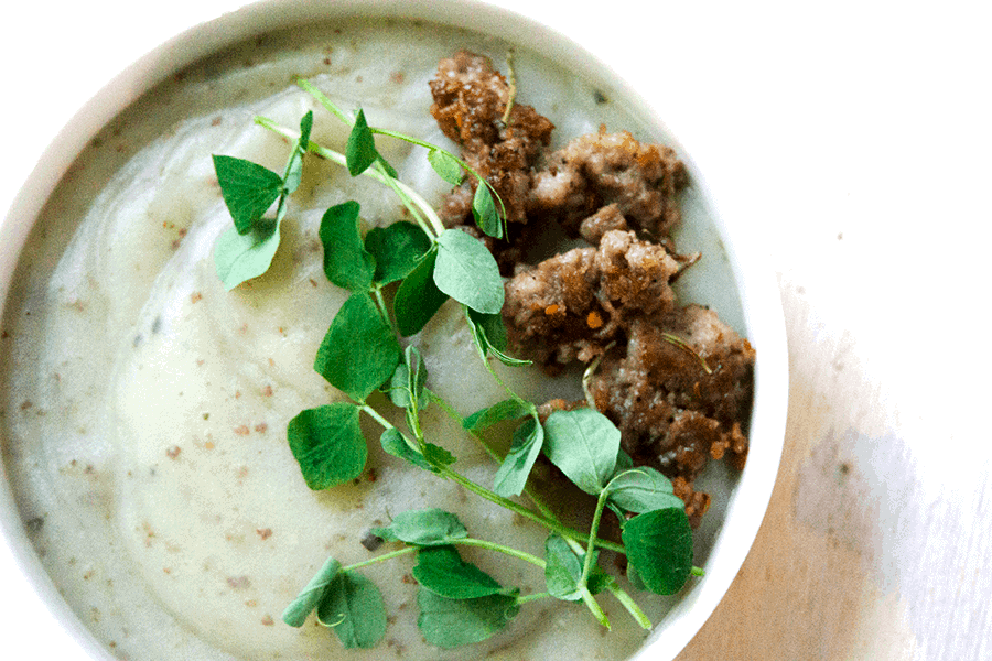 Creamy potato soup with Italian sausage and pea sprouts is savory, creamy, full of gut healing nutrients, perfect for when your craving carbs yet want to be healthy.