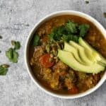 Bowl of Pumpkin Chili with Avocado and cilantro