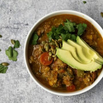 Bowl of Pumpkin Chili with Avocado and cilantro