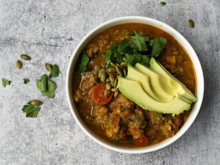 Bowl of Pumpkin Chili with Avocado and cilantro