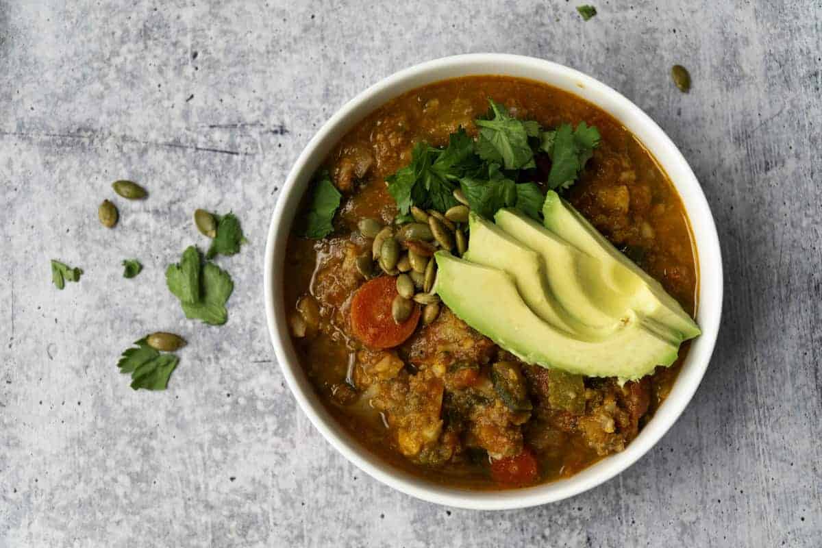 Bowl of Pumpkin Chili with Avocado and cilantro