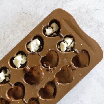Chocolate covering Coconut Butter Balls in Chocolate Molds