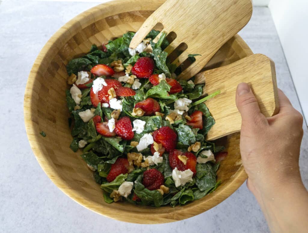 Hand Tossing Strawberry Spinach Salad