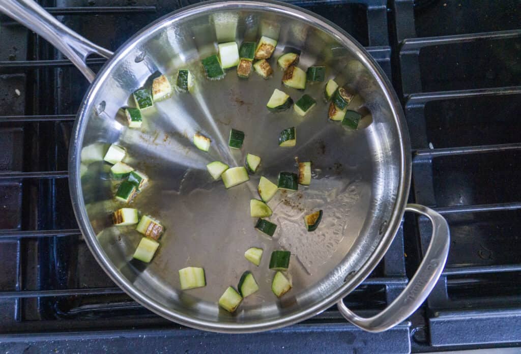 Sauteing zucchini until golden brown