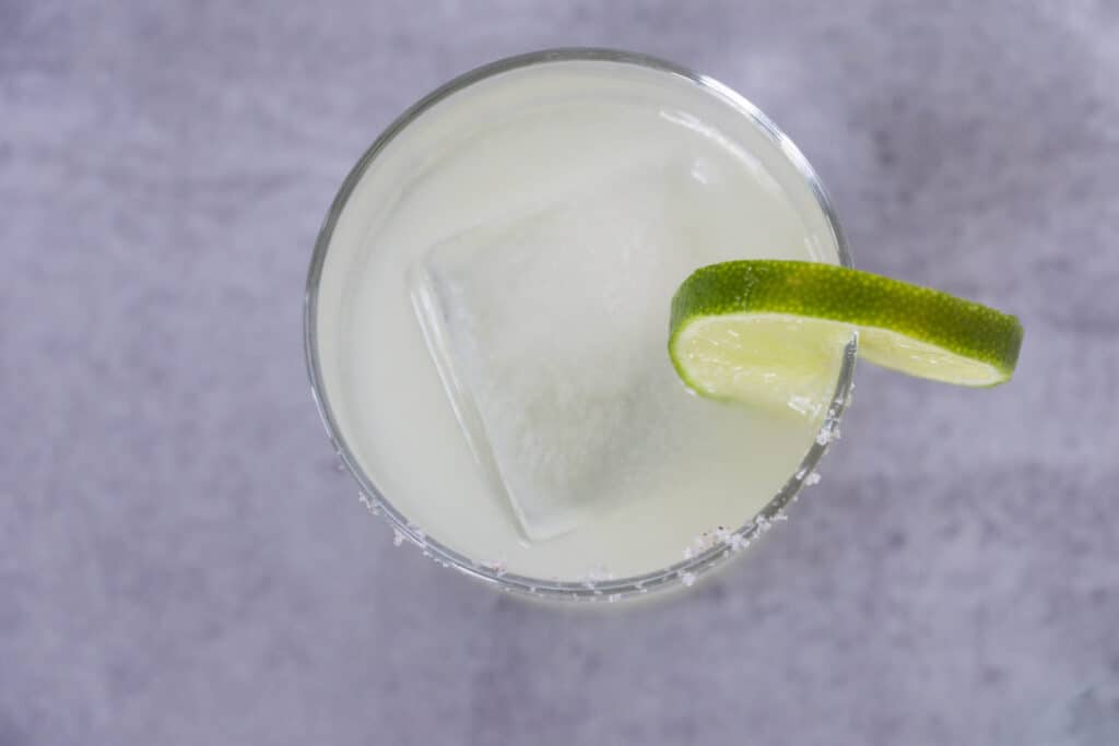Overhead view of Lime wedge in salted margarita glass