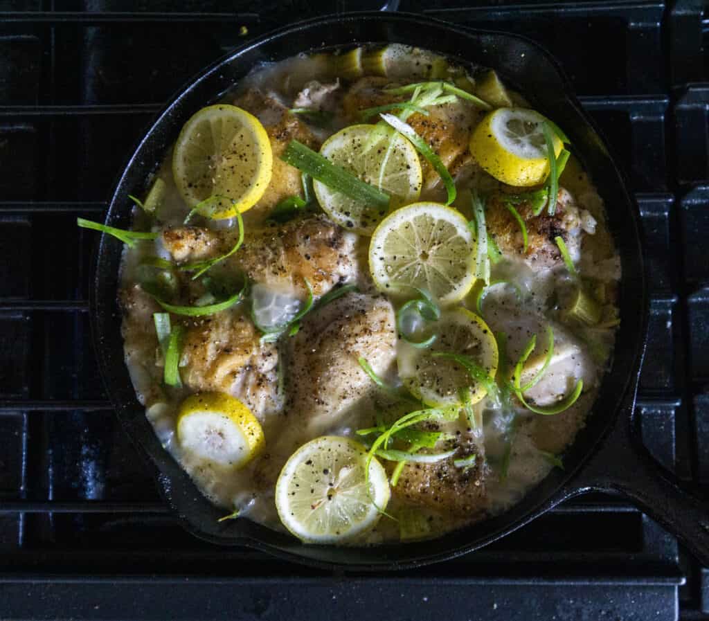 Adding the chicken back into the Rhubarb Sauce with lemons and green onion tops