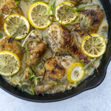 Cast iron skillet of rhubarb chicken with lemon