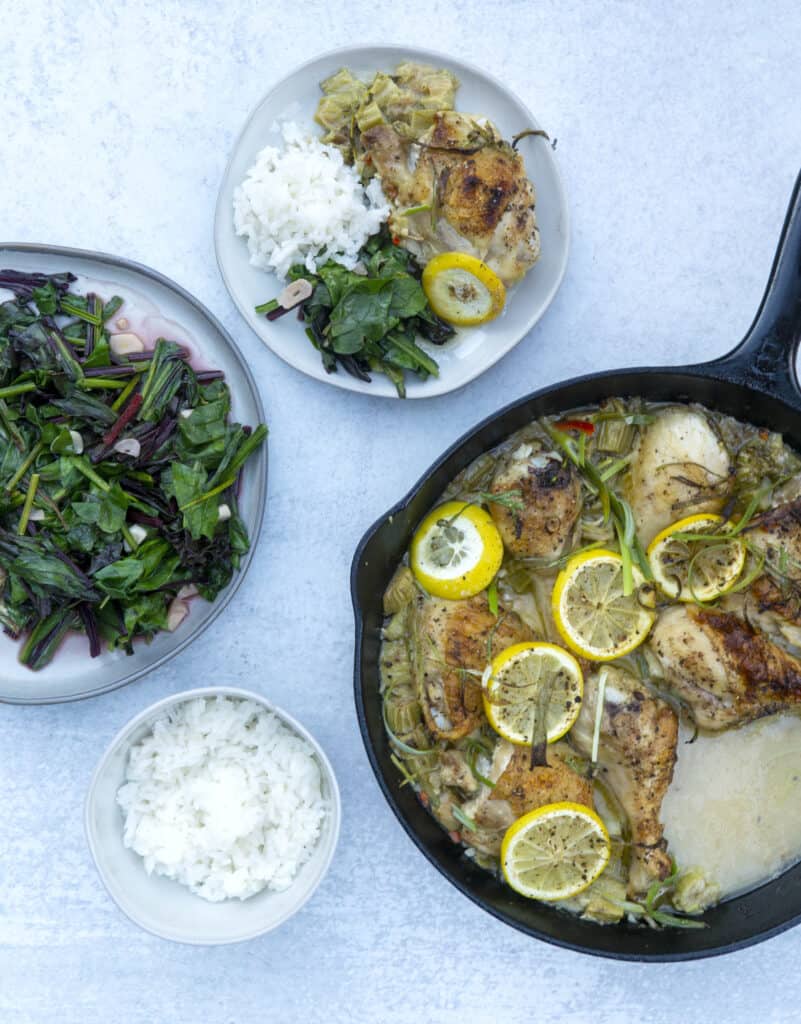 Skillet of Rhubarb Chicken and plates of garlic wilted beets and white rice