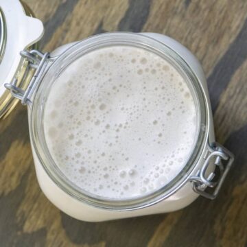 Overhead view of frothy Walnut milk in a mason jar
